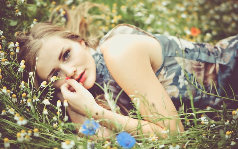 woman lying in a field of flowers