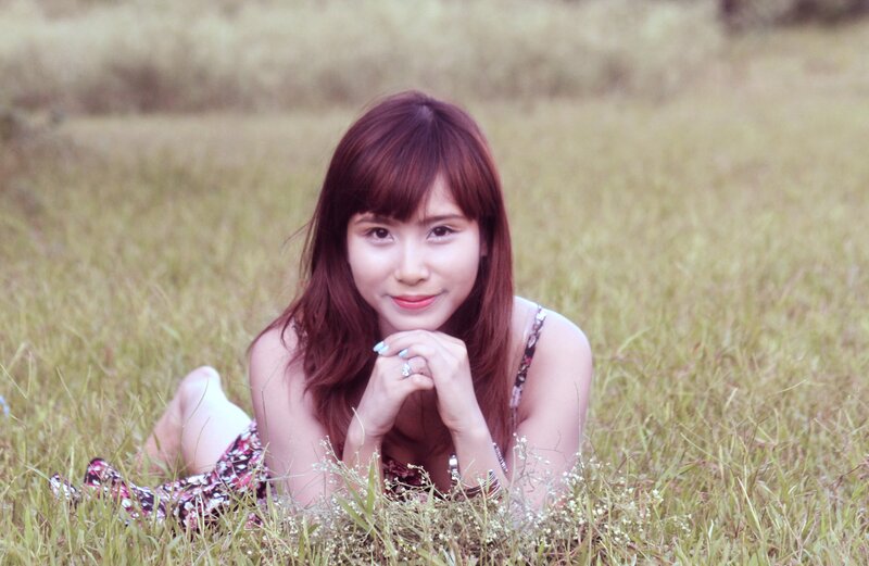 woman lying in a grassy field