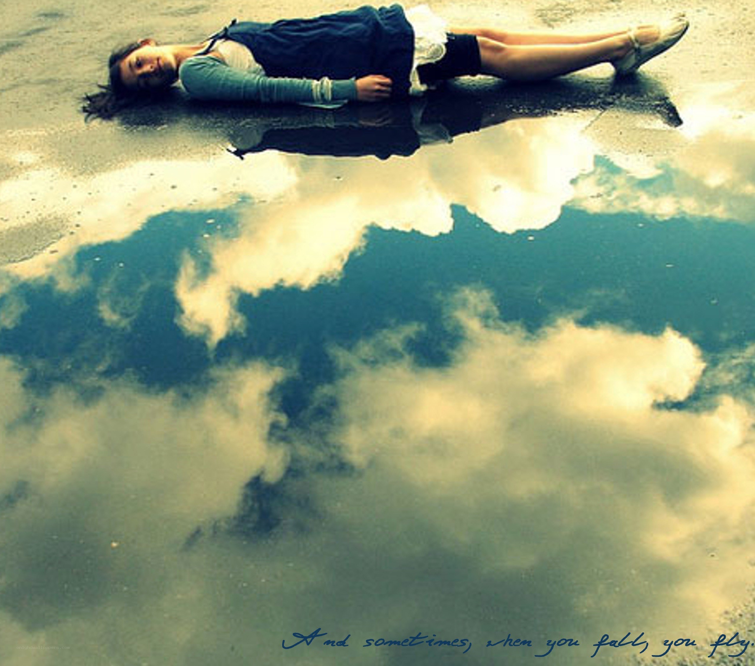 woman lying in a puddle