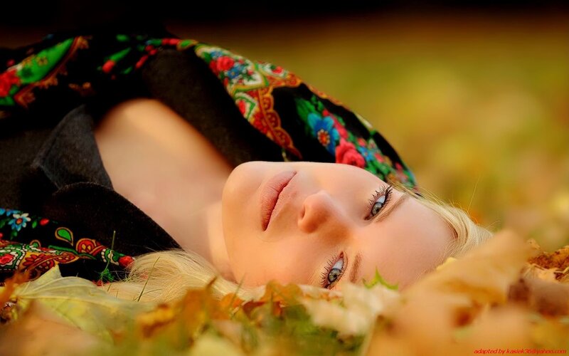 woman lying in autumn leaves