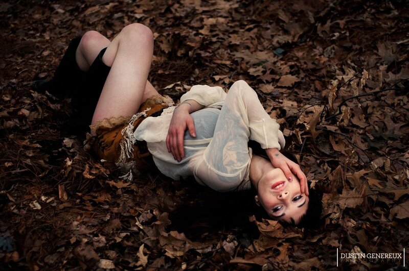 woman lying in autumn leaves