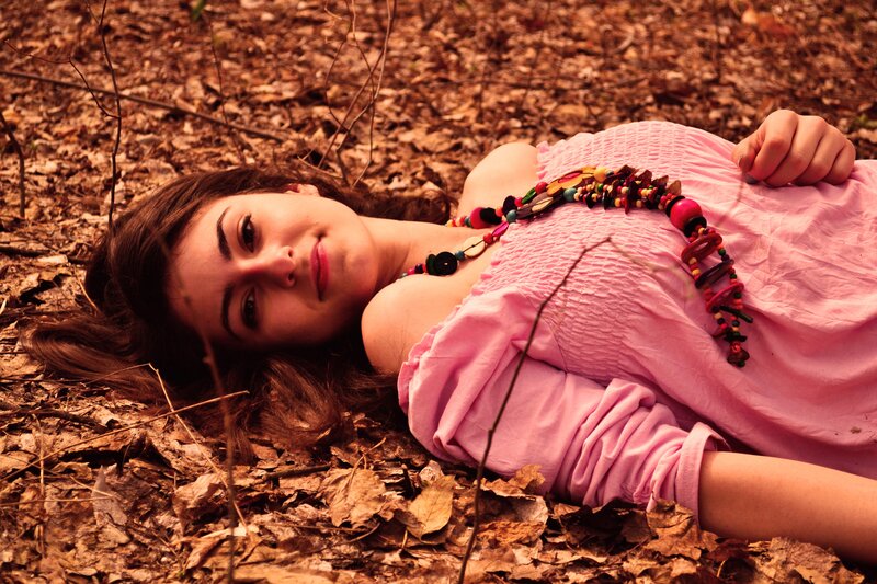 woman lying in autumn leaves