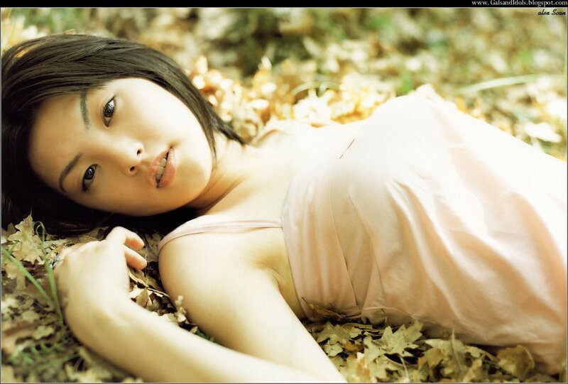 woman lying in autumn leaves