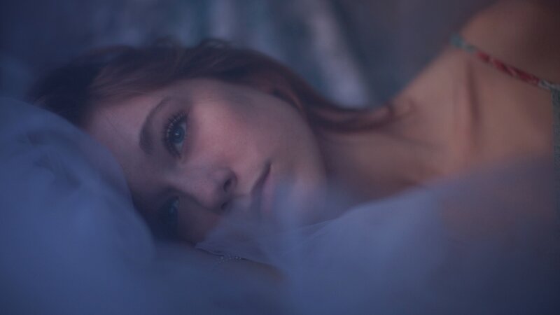 woman lying in bed at night