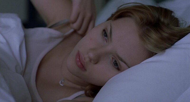 woman lying in bed awake