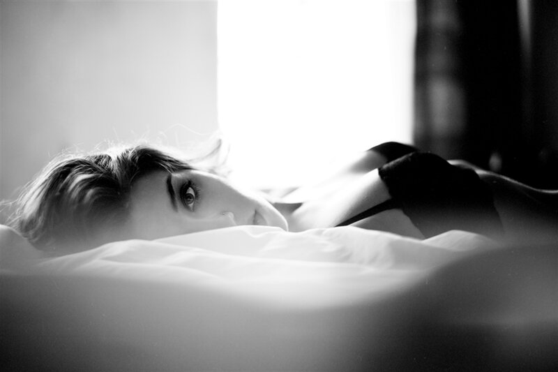 Woman Lying in Bed — Black, Dramatic, Photograph