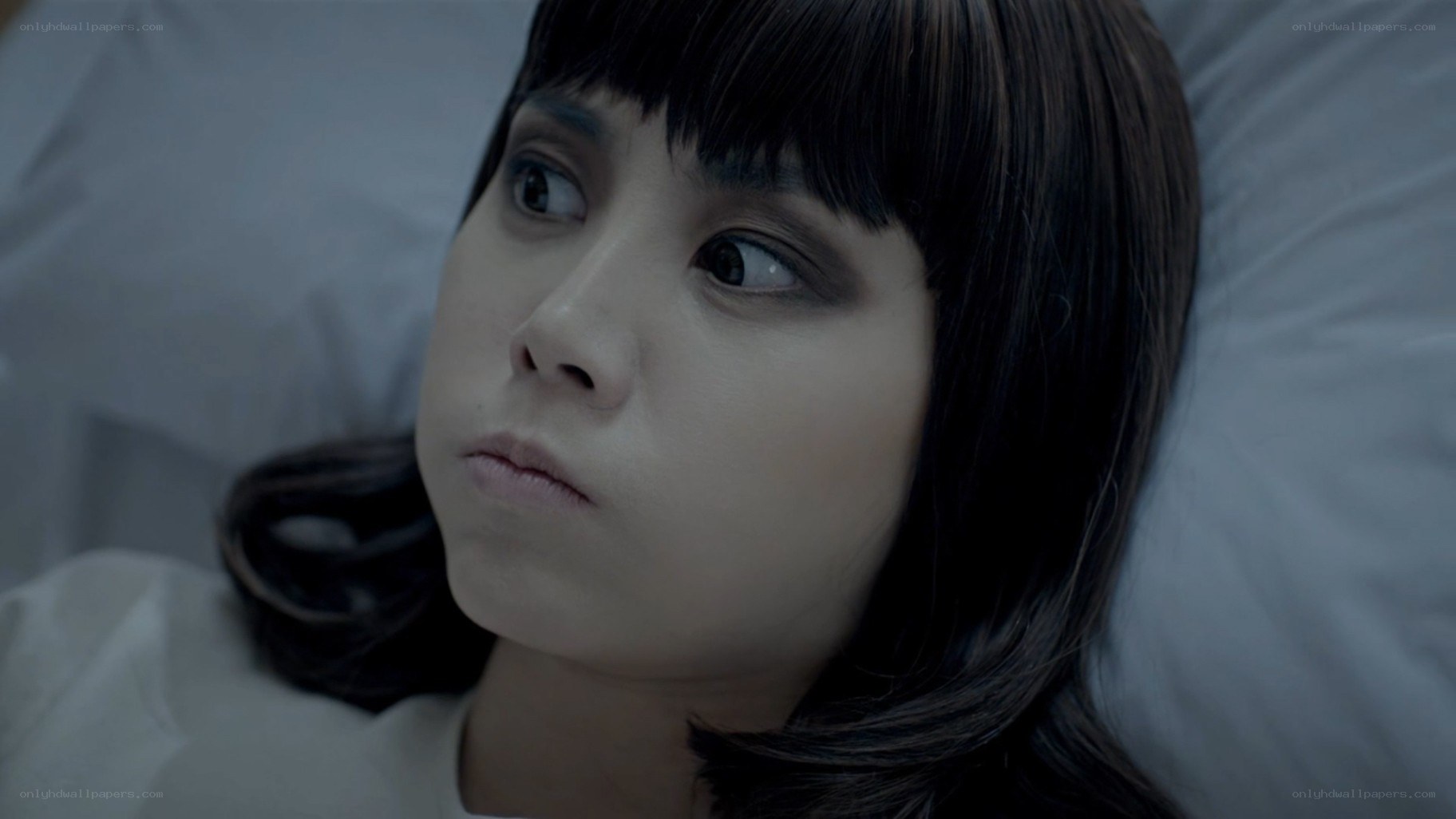 woman lying in bed looking up