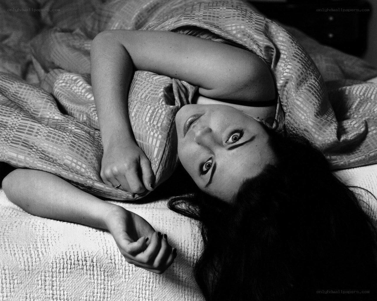 woman lying in bed looking up