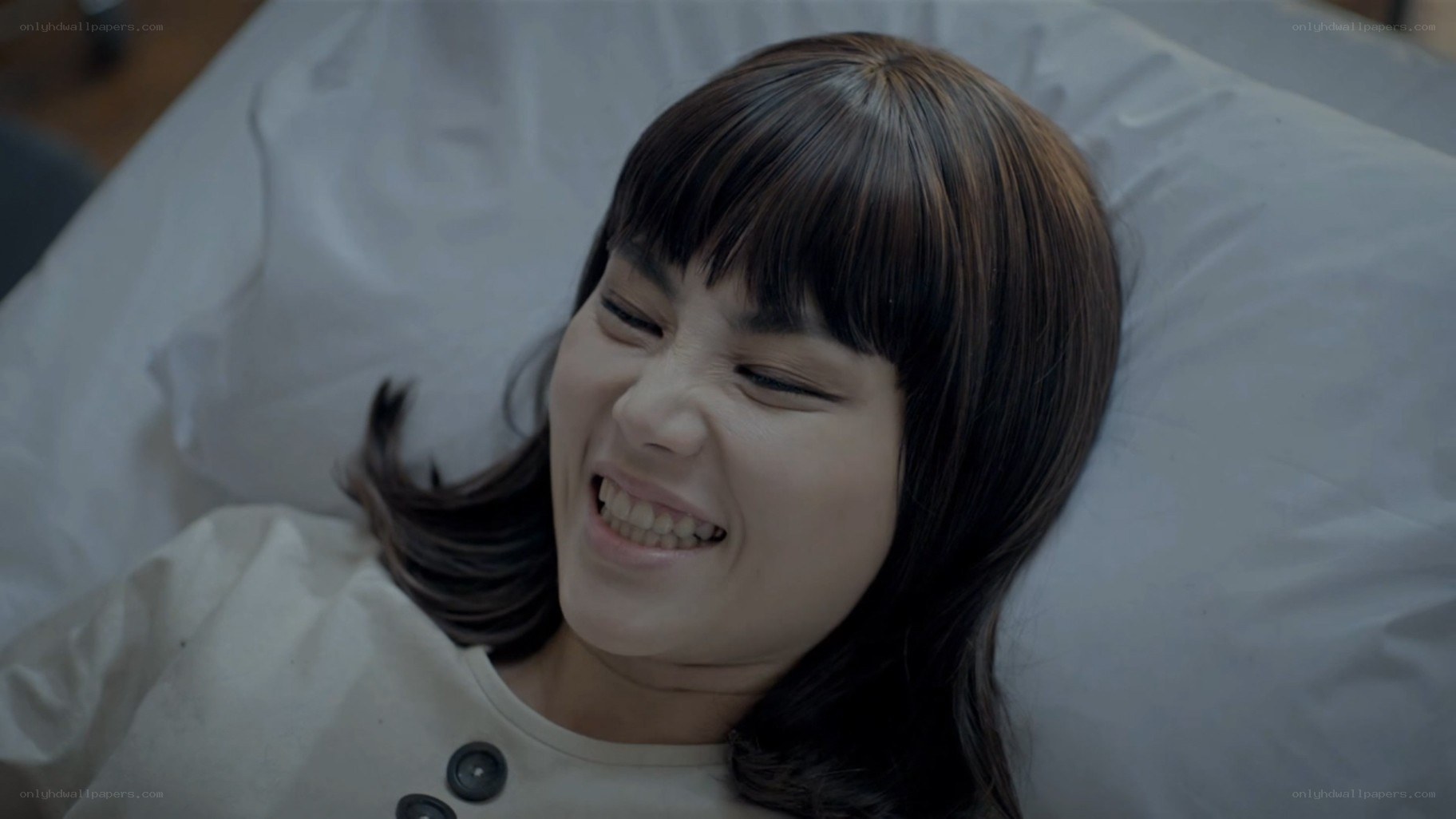 woman lying in bed smiling