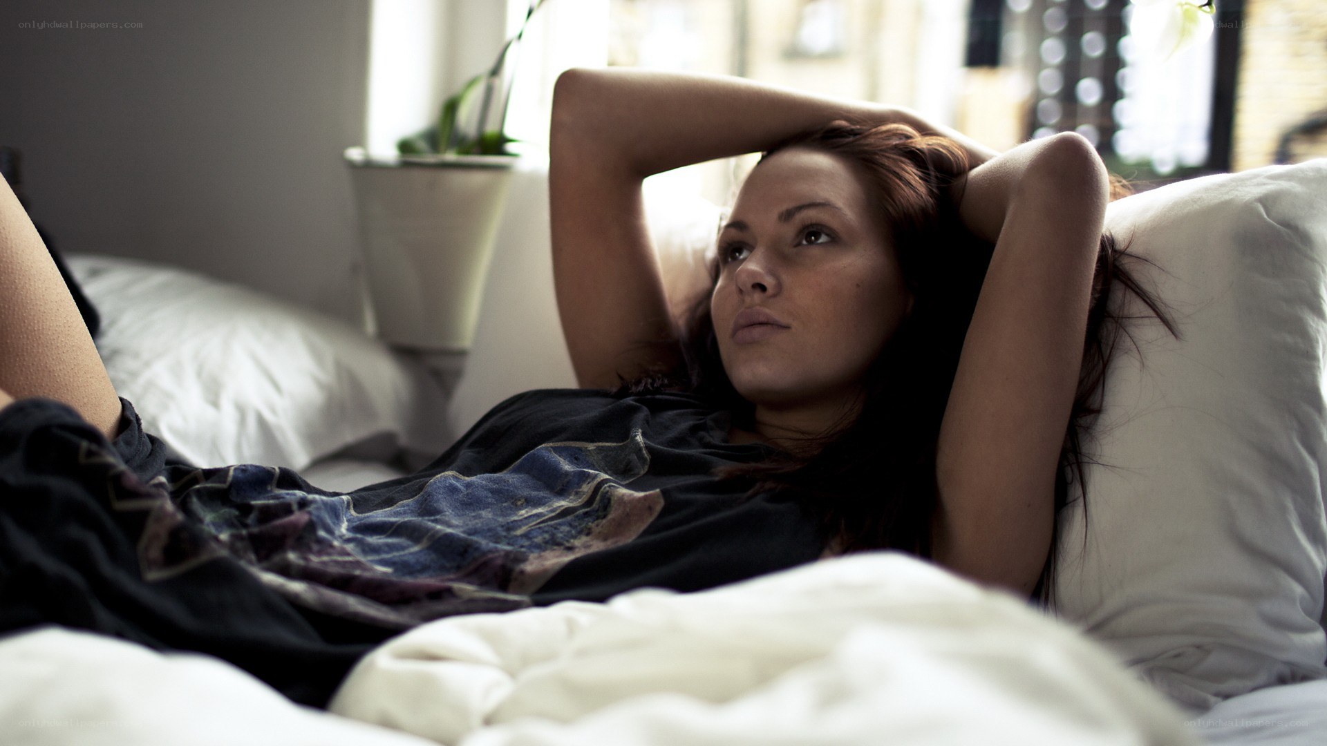 woman lying in bed thinking