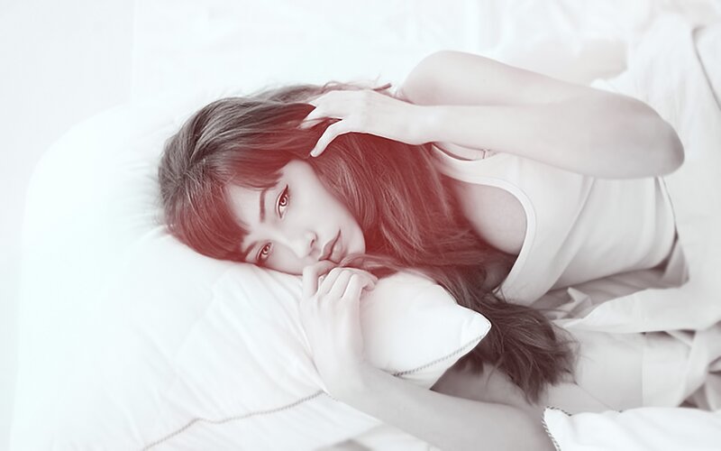 woman lying in bed with pillow