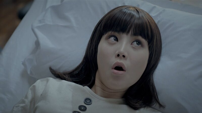 woman lying in bed with shocked expression