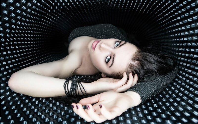 Woman Lying in Black Structure