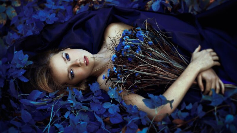 Woman Lying in Blue Leaves — Dramatic