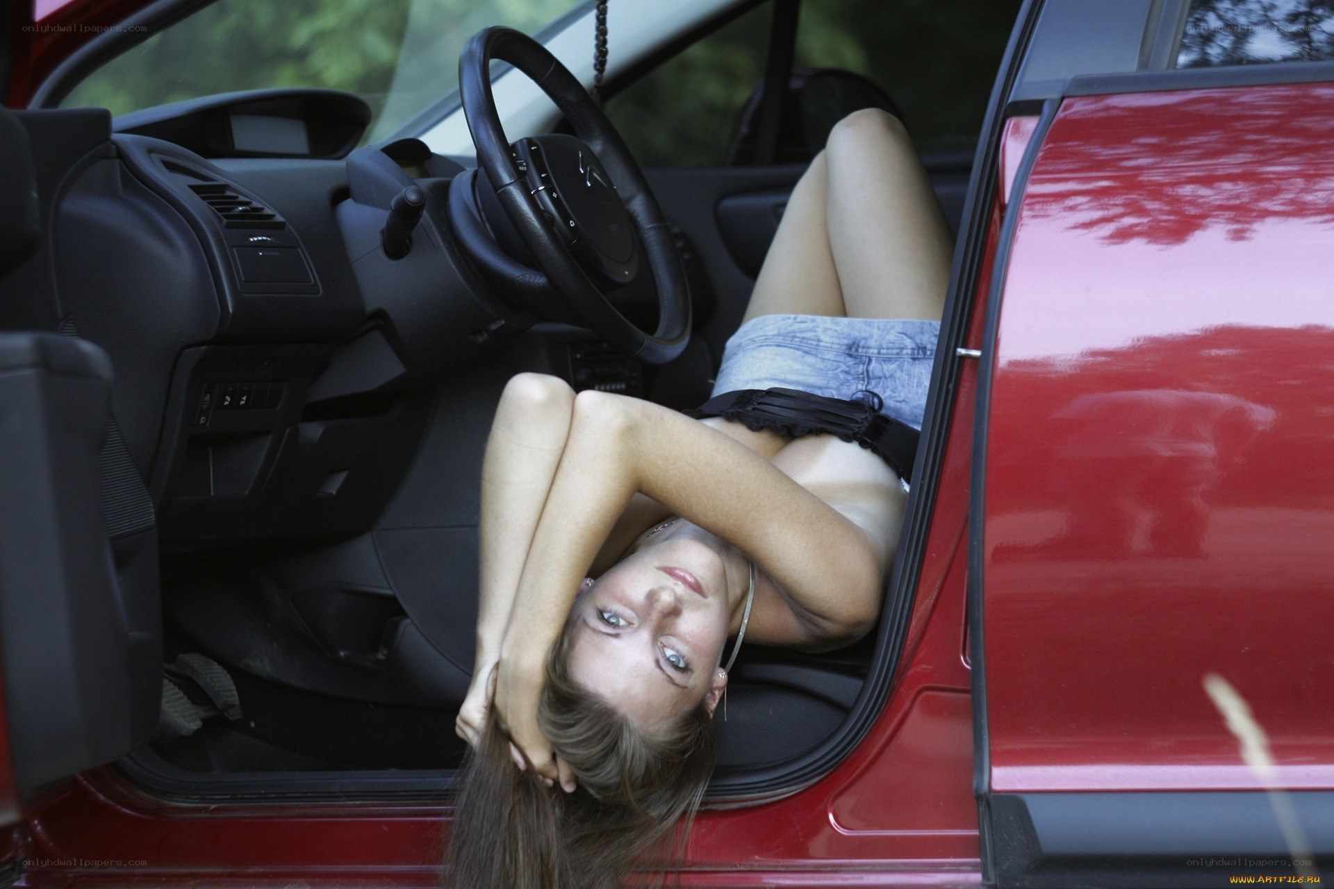 Woman lying in car interior