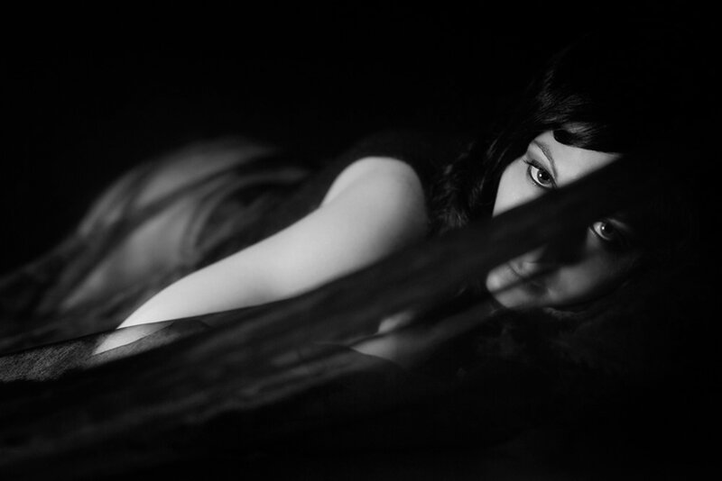 Woman Lying in Darkness