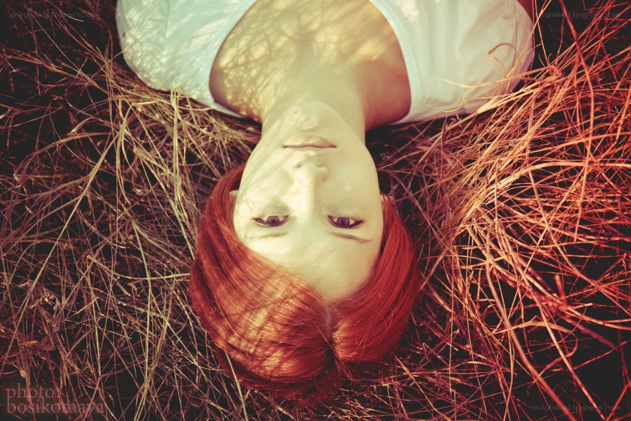 woman lying in dry grass