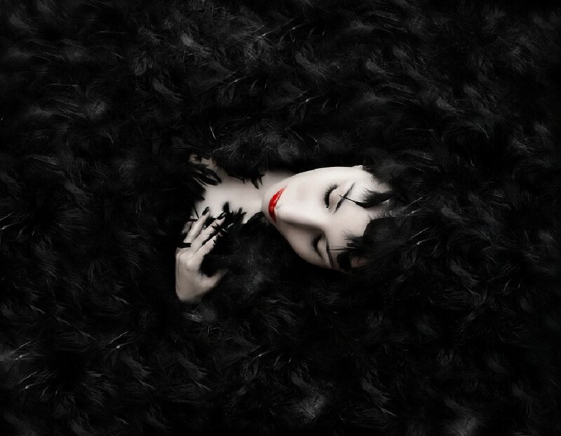 Woman Lying in Feathers