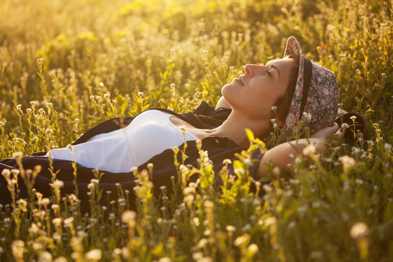 Woman Lying in Field — Green, Serene, Sunset