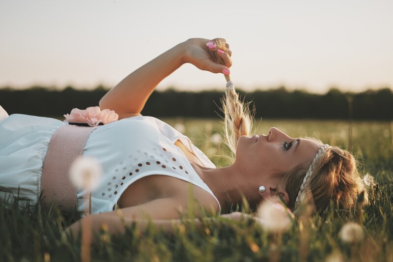 Woman Lying in Field — White, Serene, Sunset