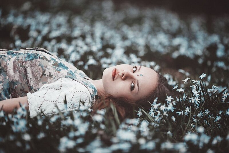 Woman Lying in Flowers — White, Serene, Spring