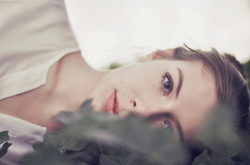 woman lying in foliage