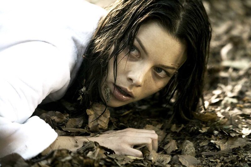 woman lying in forest leaves