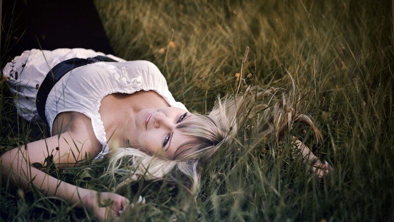 Woman lying in grass