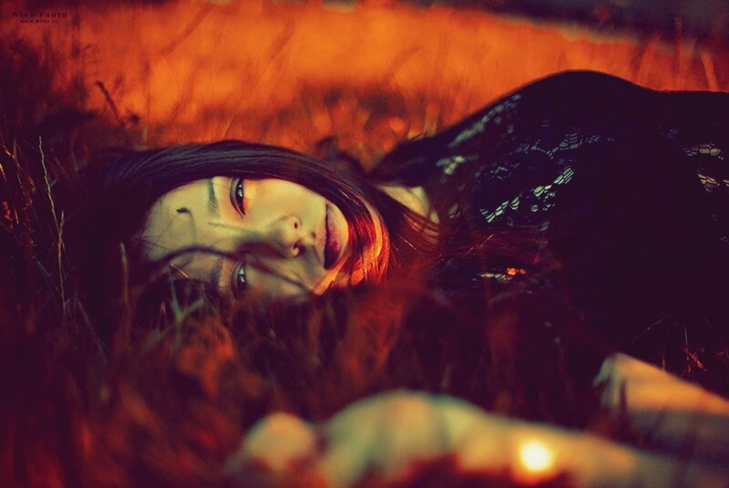 woman lying in grass at night