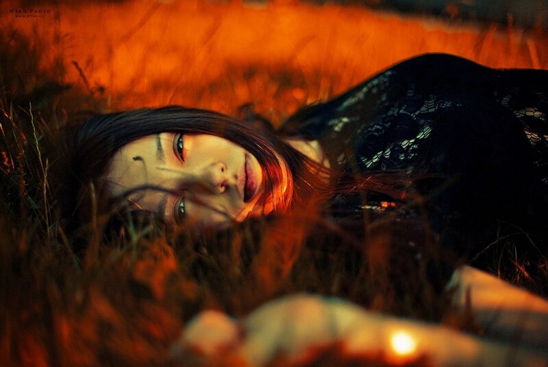 woman lying in grass at sunset