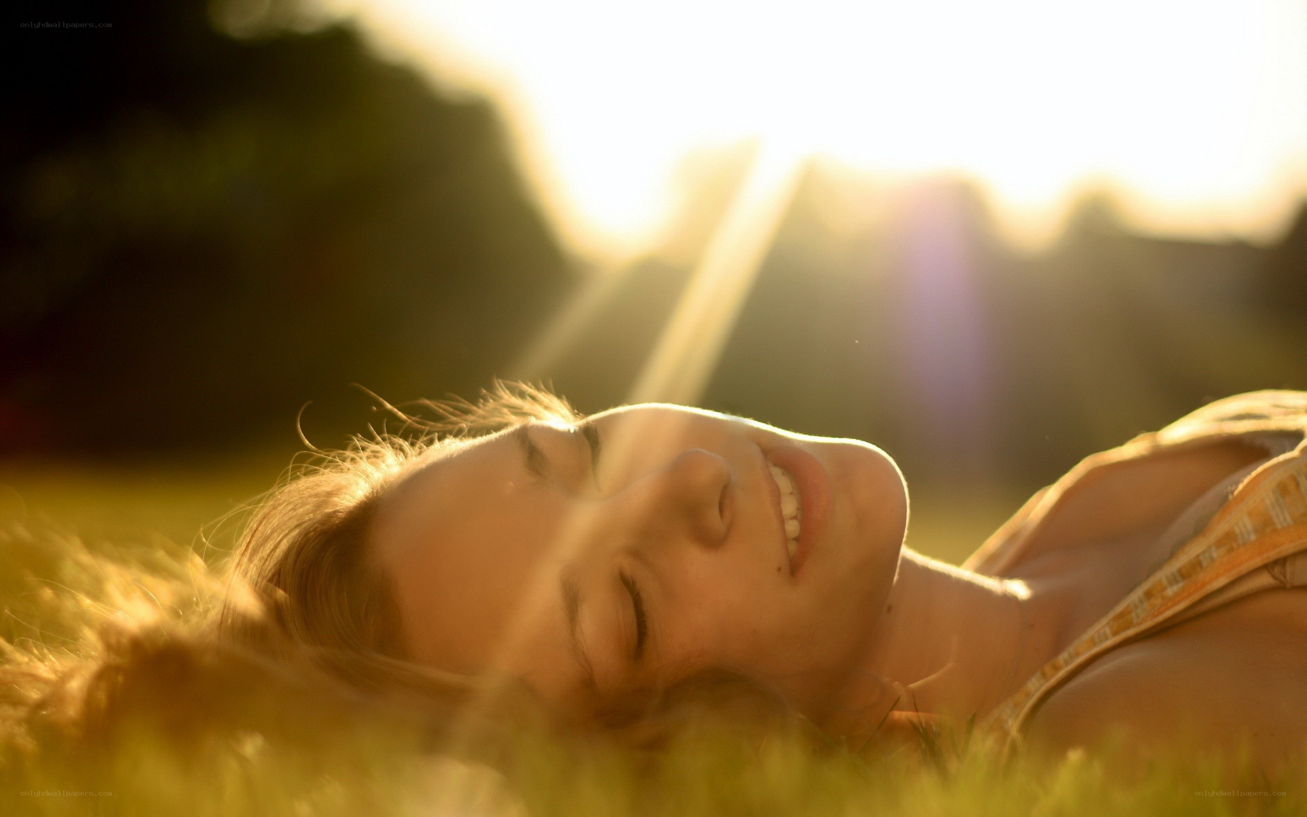 woman lying in grass at sunset