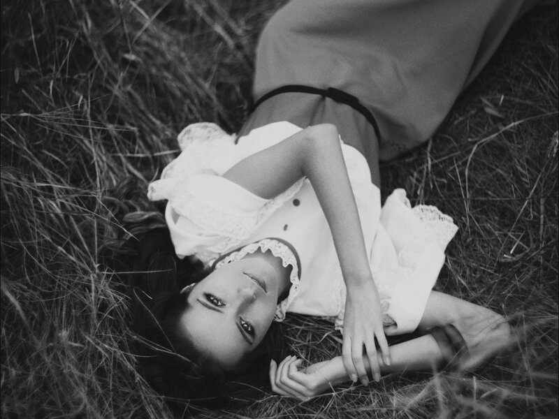 Woman Lying in Grass — Black, Serene, Photograph, Dress