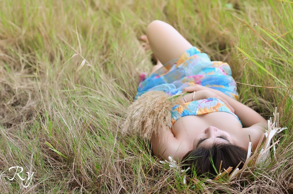 woman lying in grass field