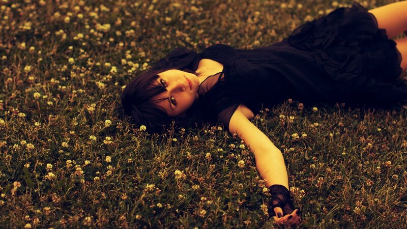 Woman Lying in Grass — Green, Calm, Sunset, Photograph, Flowers, Black Dress