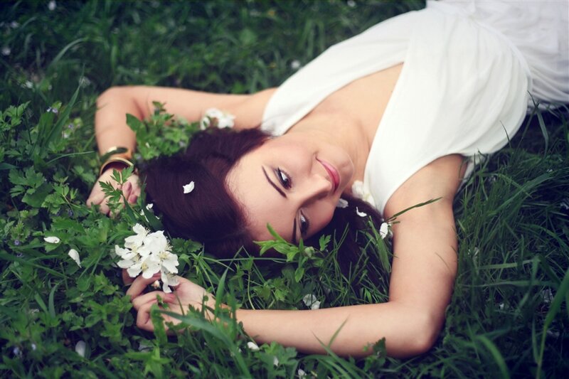 Woman Lying in Grass — Green, Serene, Spring, Photograph, White Flowers