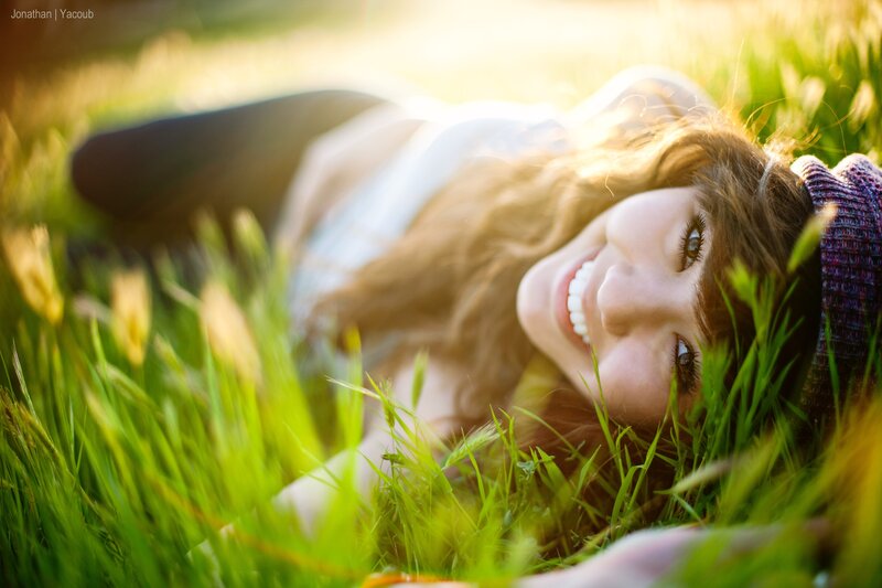 Woman Lying in Grass — Green, Serene, Sunset, Photograph, Sunlight, Hat
