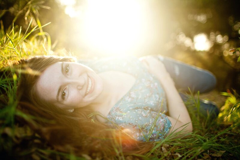 Woman Lying in Grass — Green, Serene, Sunset, Photograph, Sunlight, Jeans