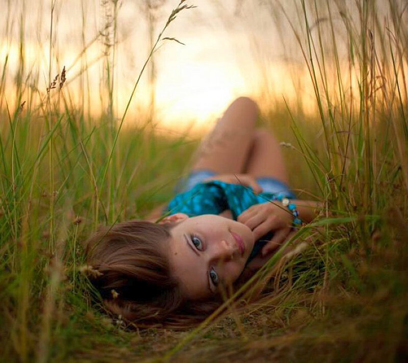 Woman Lying in Grass — Green, Serene, Sunset, Photograph