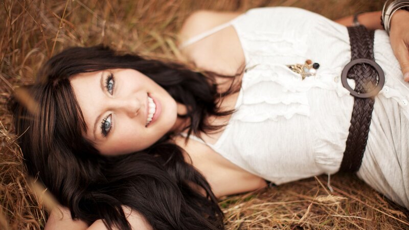 woman lying in grass smiling