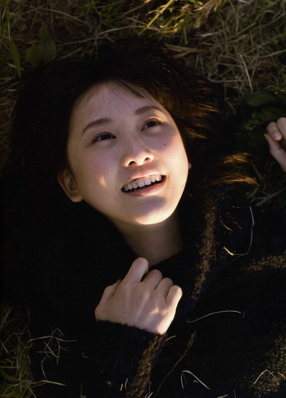 woman lying in grass smiling