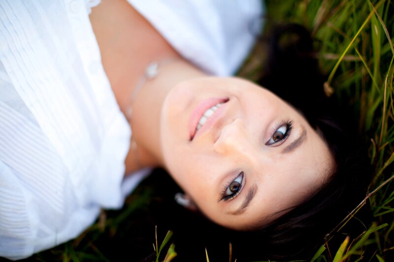 woman lying in grass smiling
