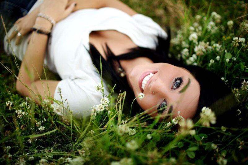 woman lying in grass smiling