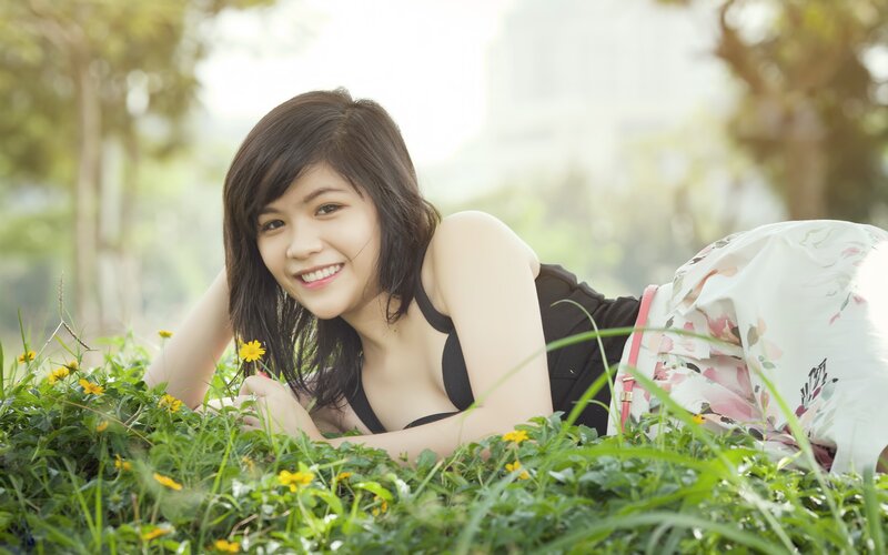 woman lying in grass smiling