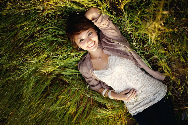 woman lying in grass smiling