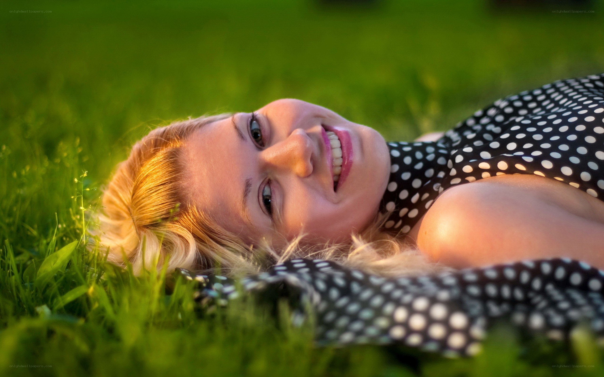 woman lying in grass smiling