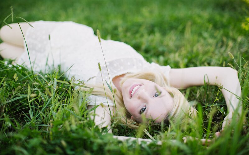 woman lying in grass smiling