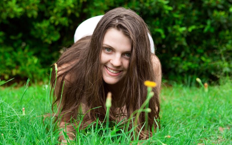 woman lying in grass smiling