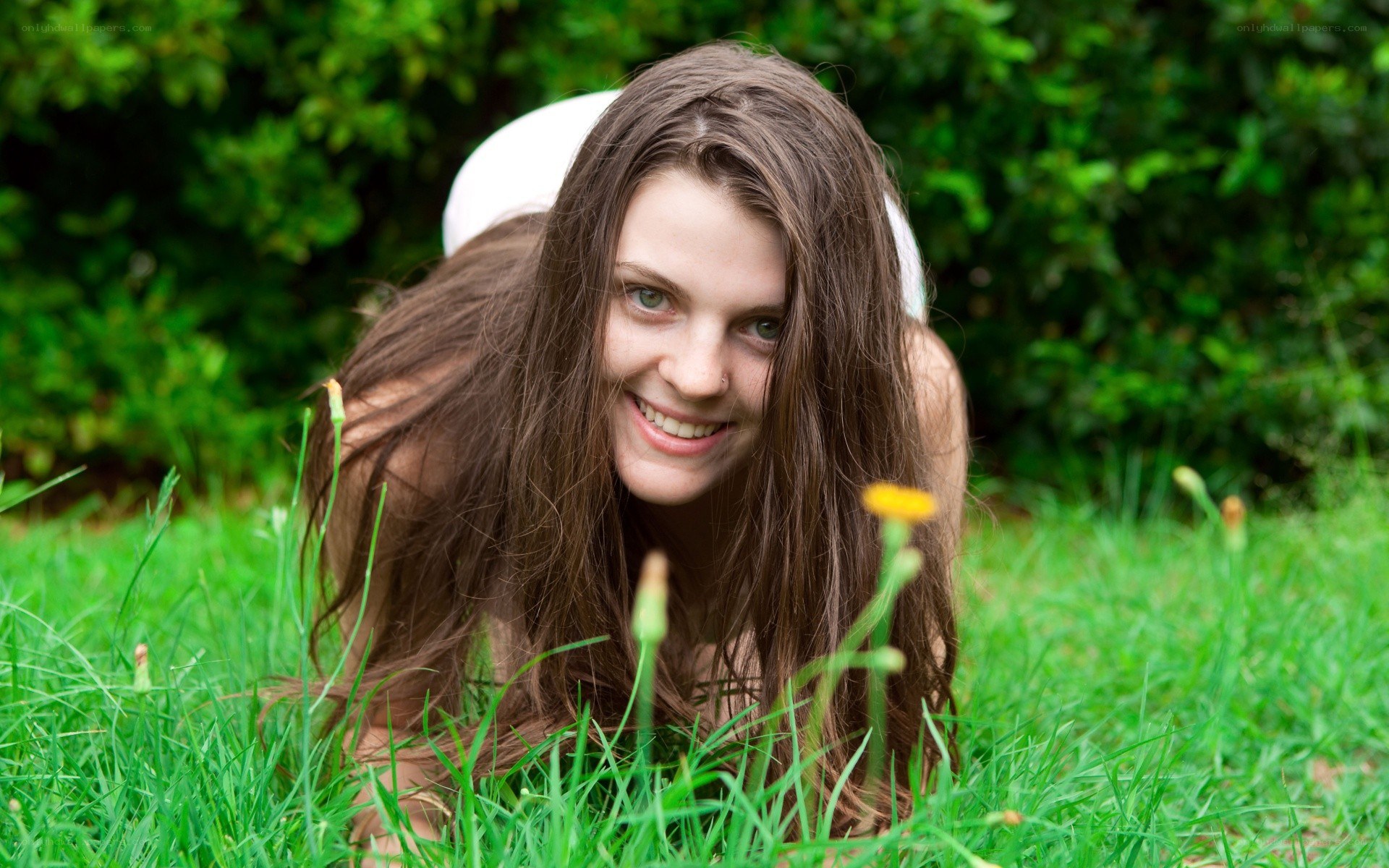 woman lying in grass smiling