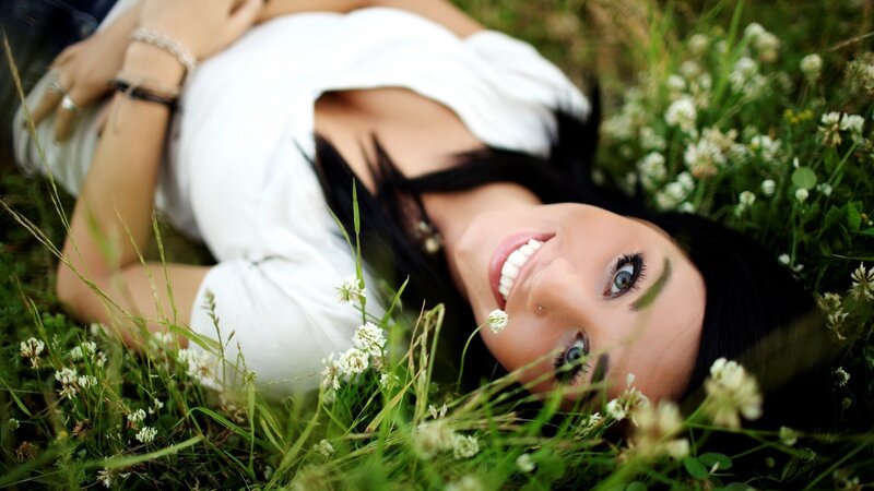 woman lying in grass smiling