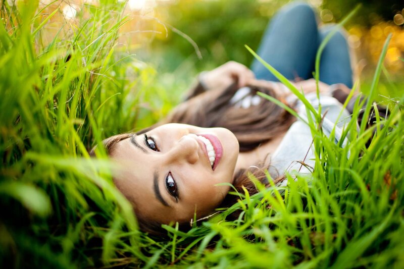 woman lying in grass smiling